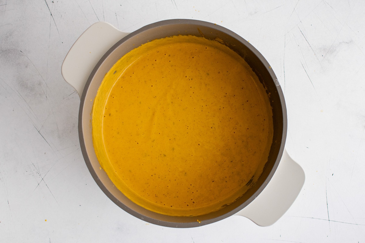 Creamy orange sauce in a sauce pan.