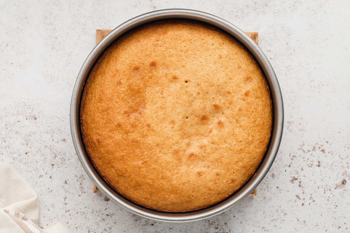 Round cake pan with baked cake.