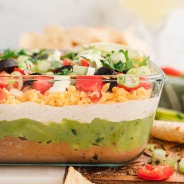 7 layer dip side view in a clear serving dish.