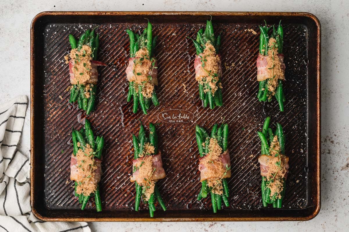 Green bean bundles wrapped in bacon and sprinkled with salt, pepper and brown sugar,