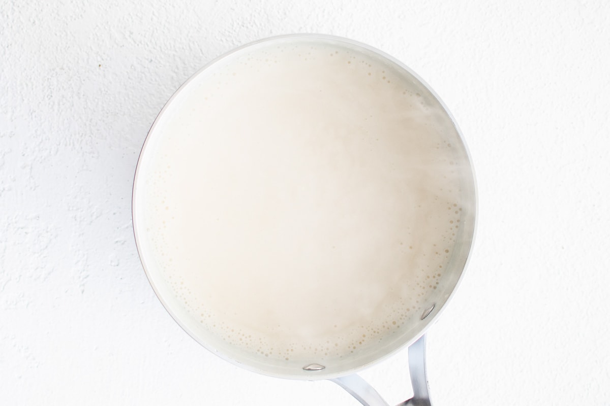 White sauce in a metal pot.