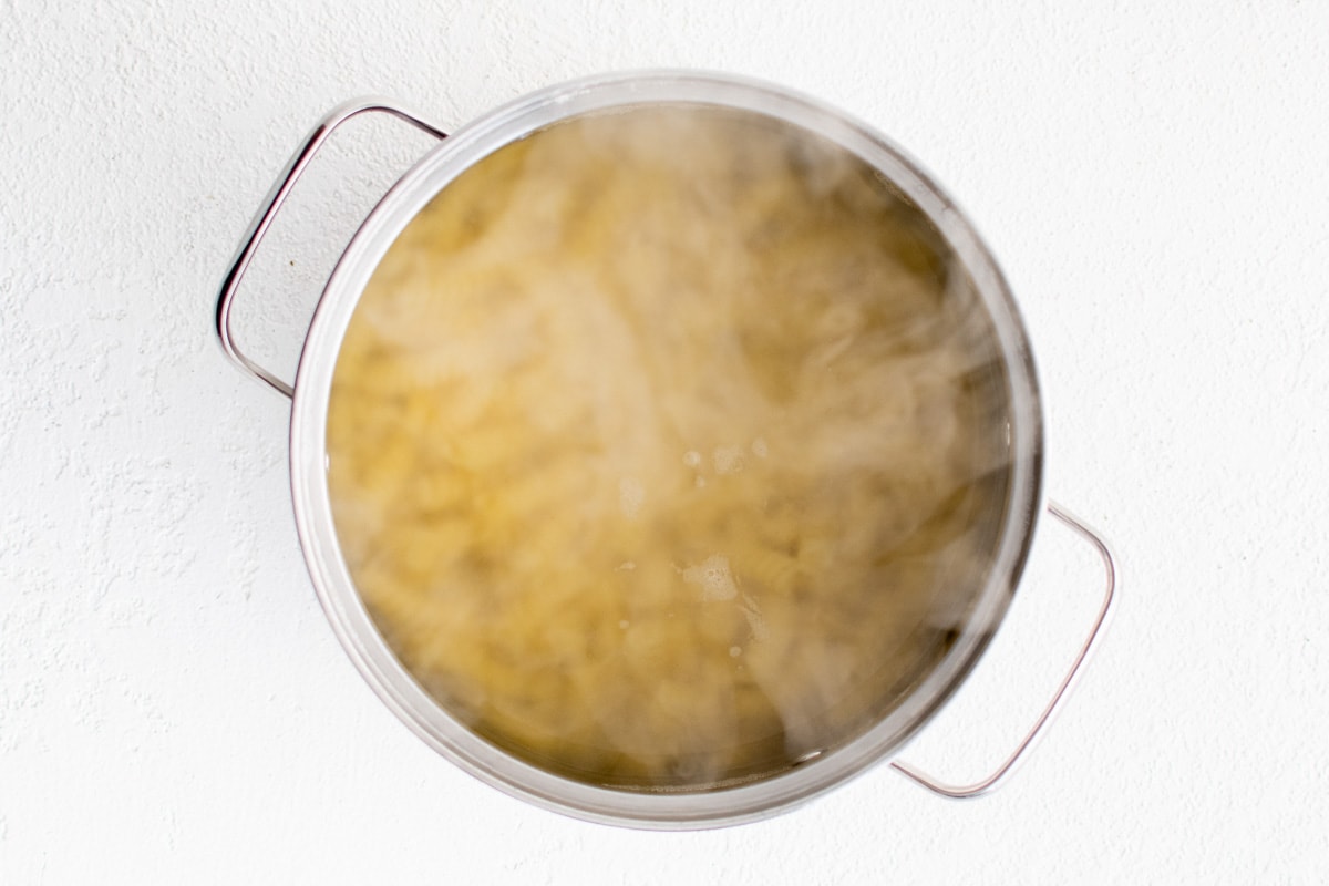 Pasta in boiling water in a pot.