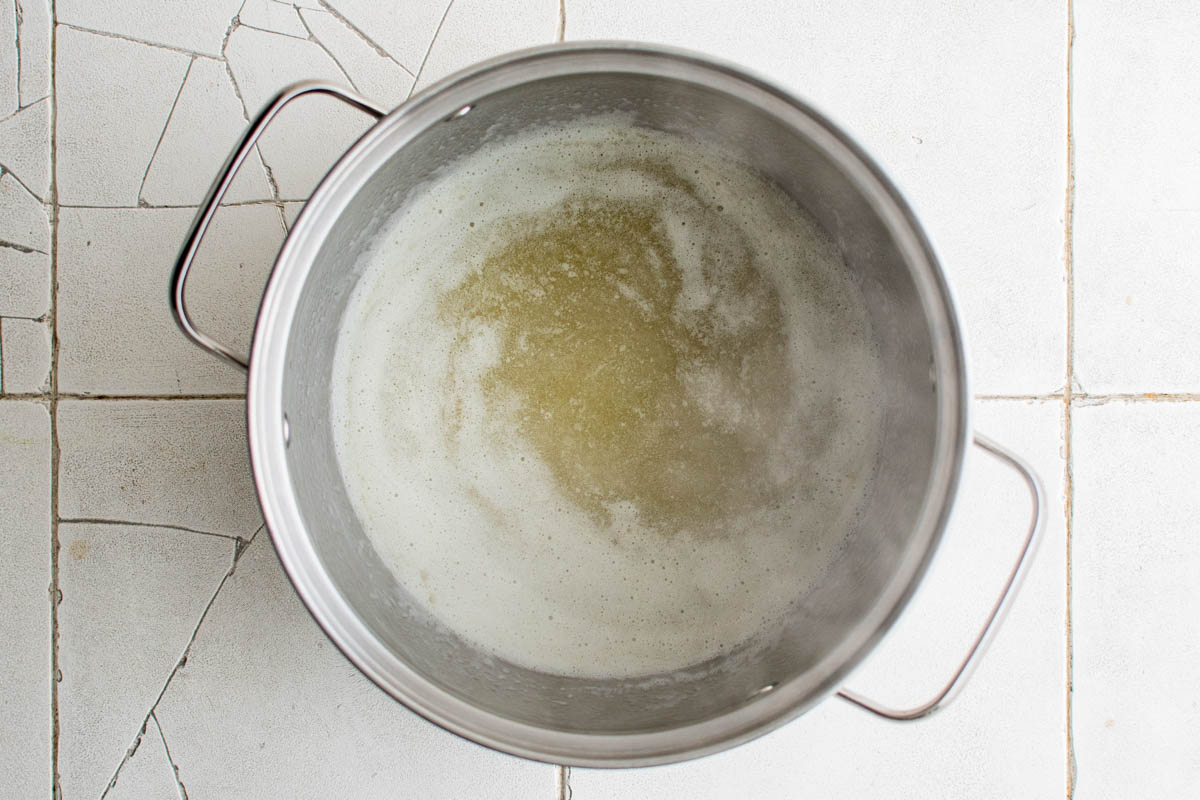 Melted butter in a metal pot.