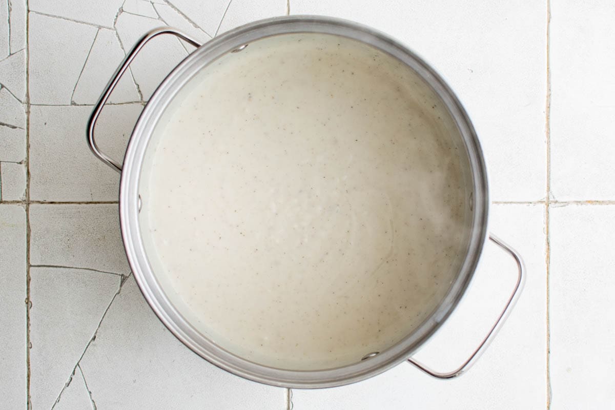 Bechamel sauce in a metal pan.