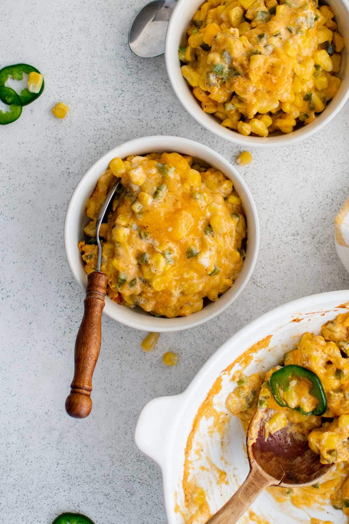 corn jalapeno casserole serving in a small bowl iwth a fork.