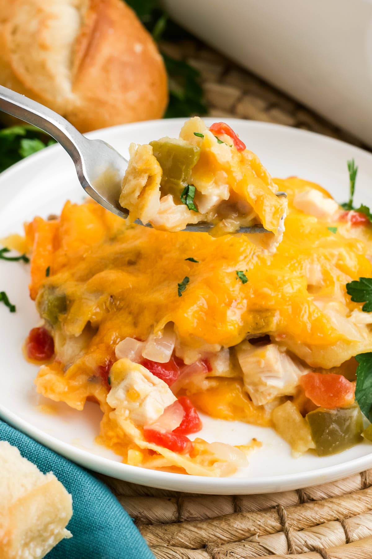chicken and cheese casserole portion on a small plate with a fork.