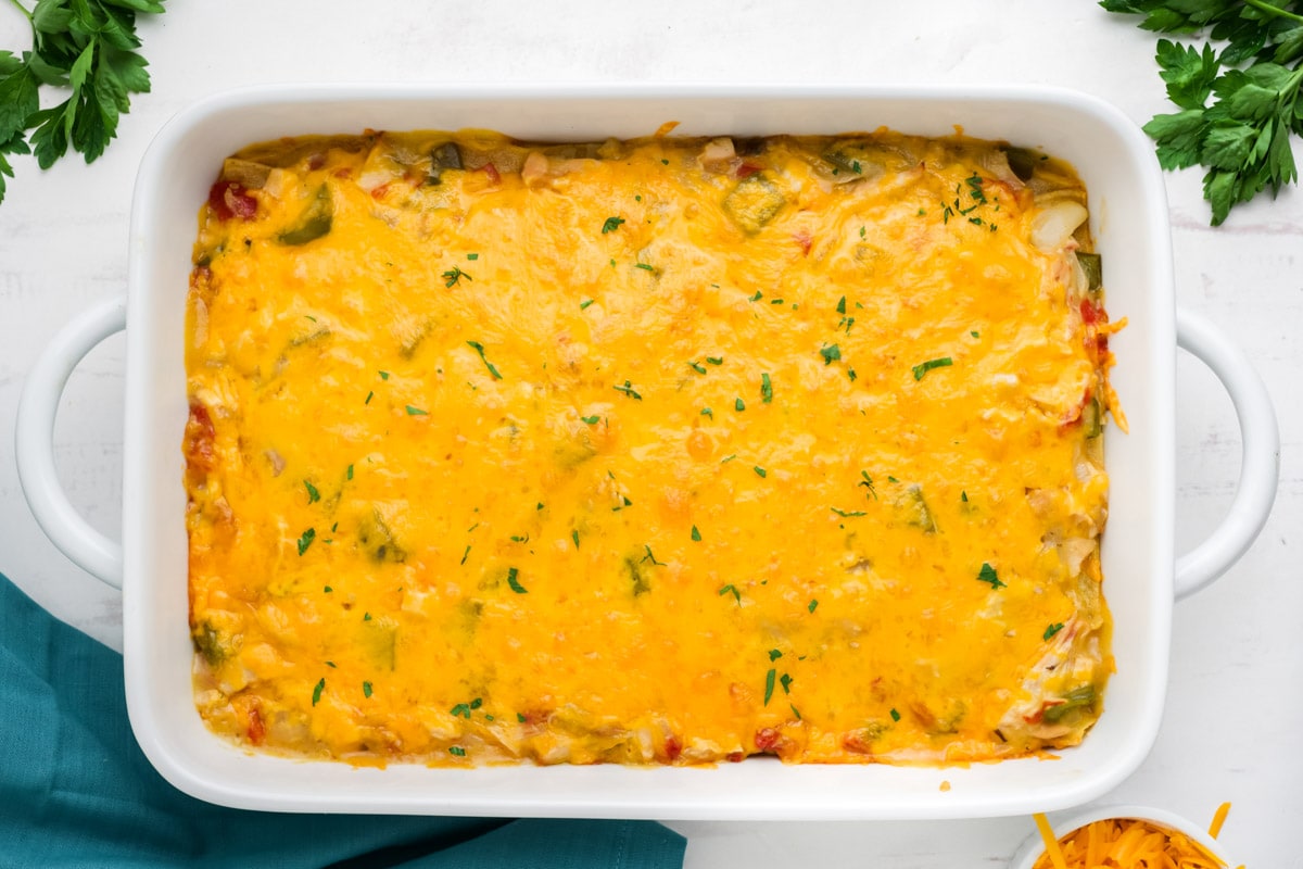 Baked casserole with melted cheese on top in a white casserole dish.