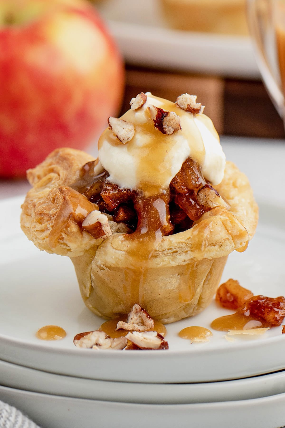 Apples with caramel and whipped cream in a tart shell.