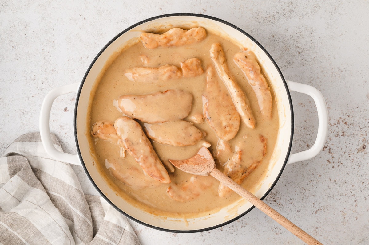 Chicken tenders added to the pan of gravy.