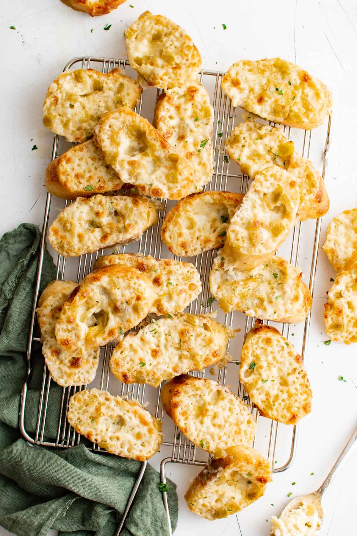 Small pieces of toasted bread with cheese and green chiles.