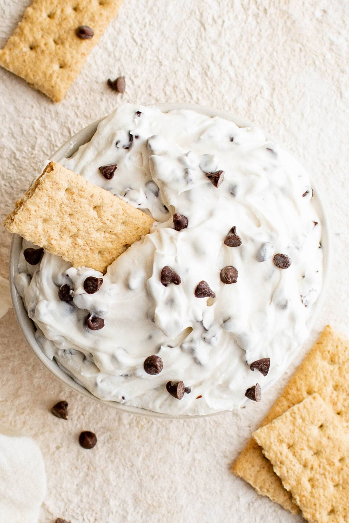 Chocolate chip dip with a graham cracker.