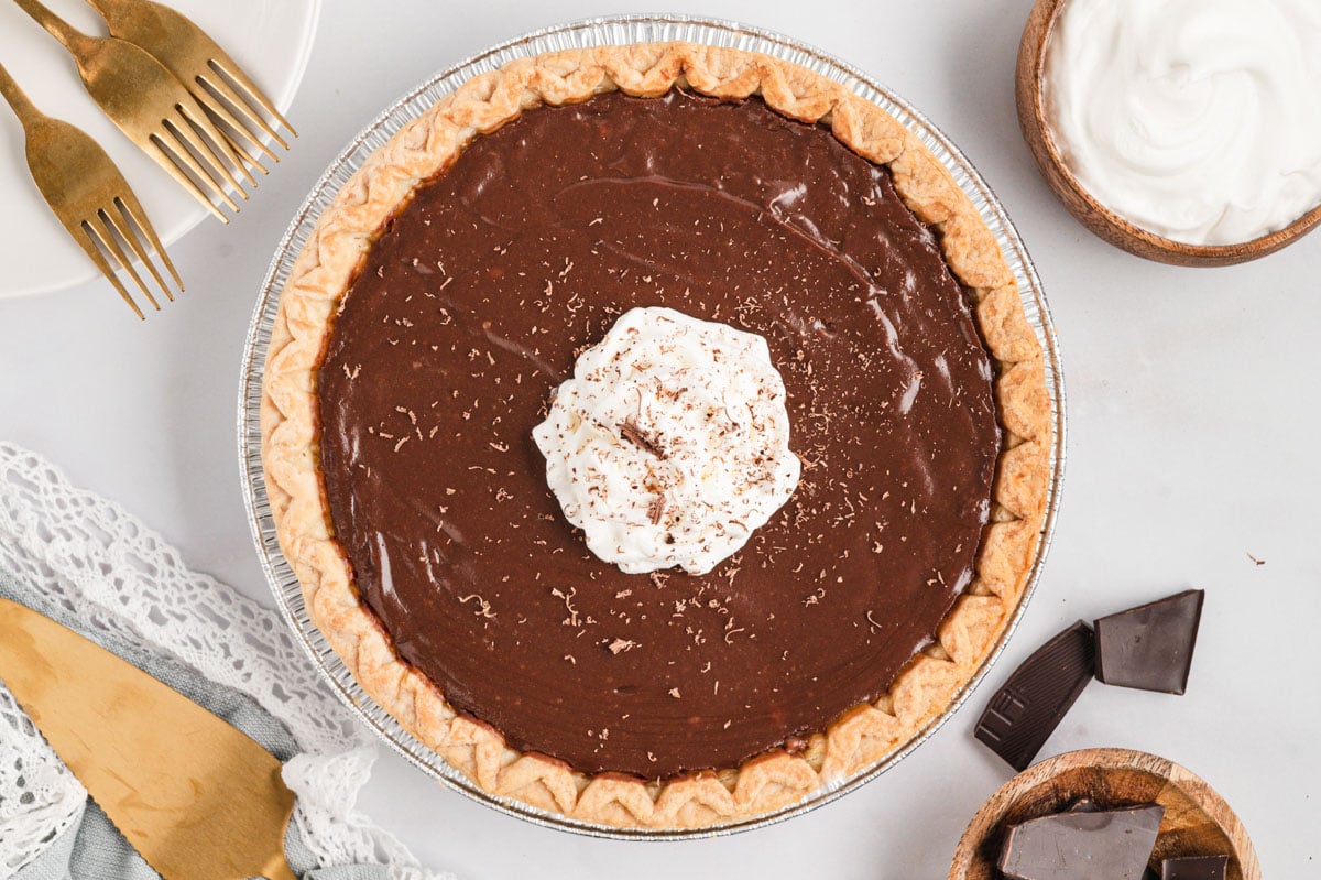 Chocolate pie in a pie crust with whipped cream.