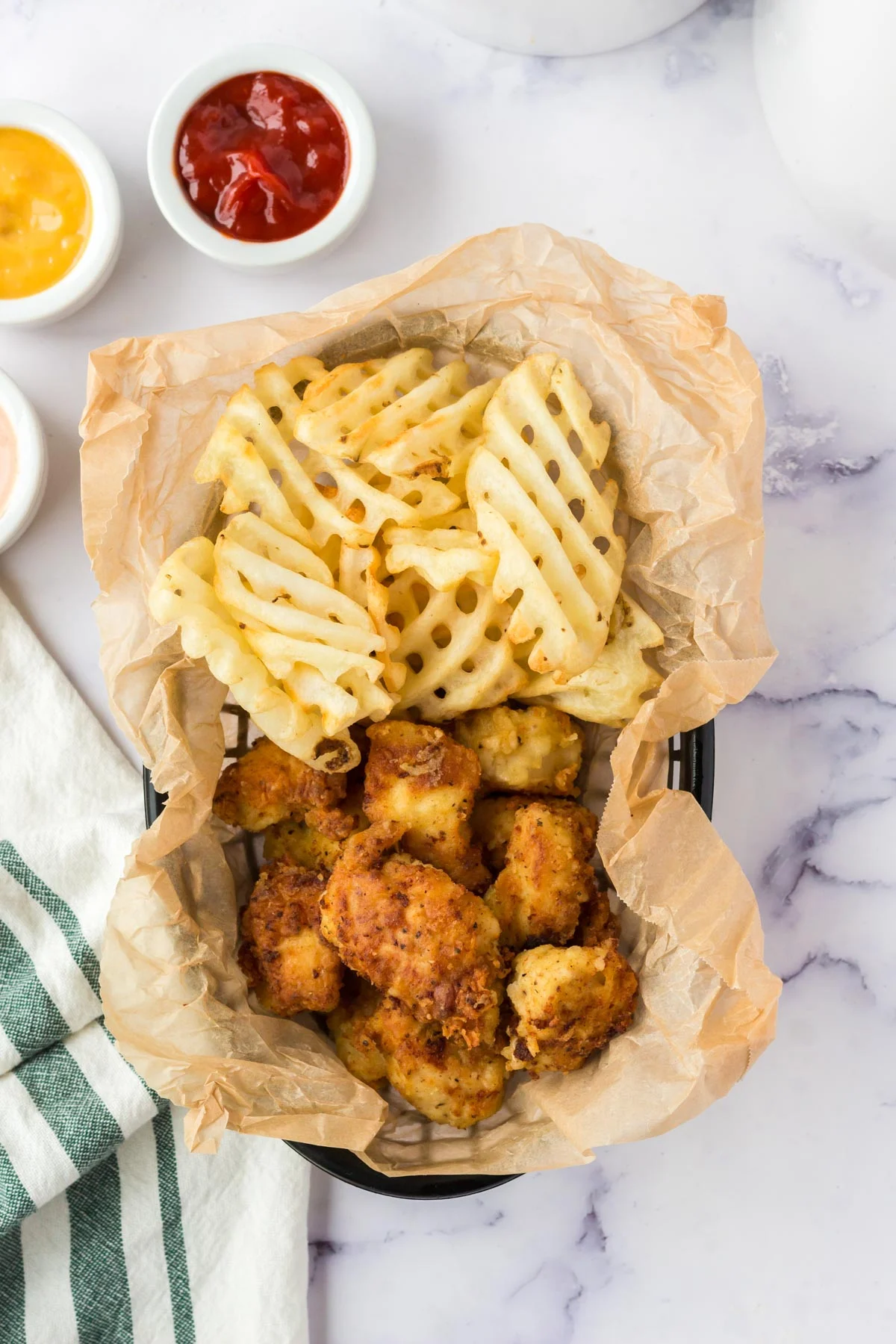 Chick Fil A Chicken nuggets copycat with waffle fries in a basket. 