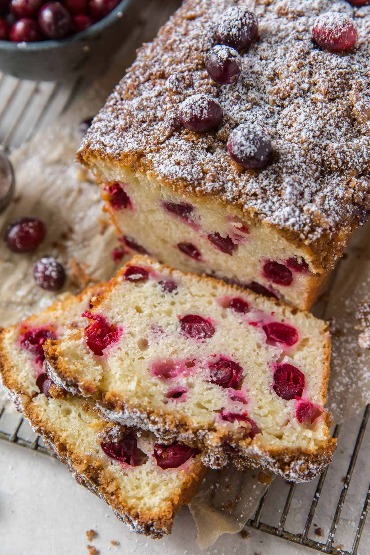 Cranberry bread, sliced, on a wire rack.