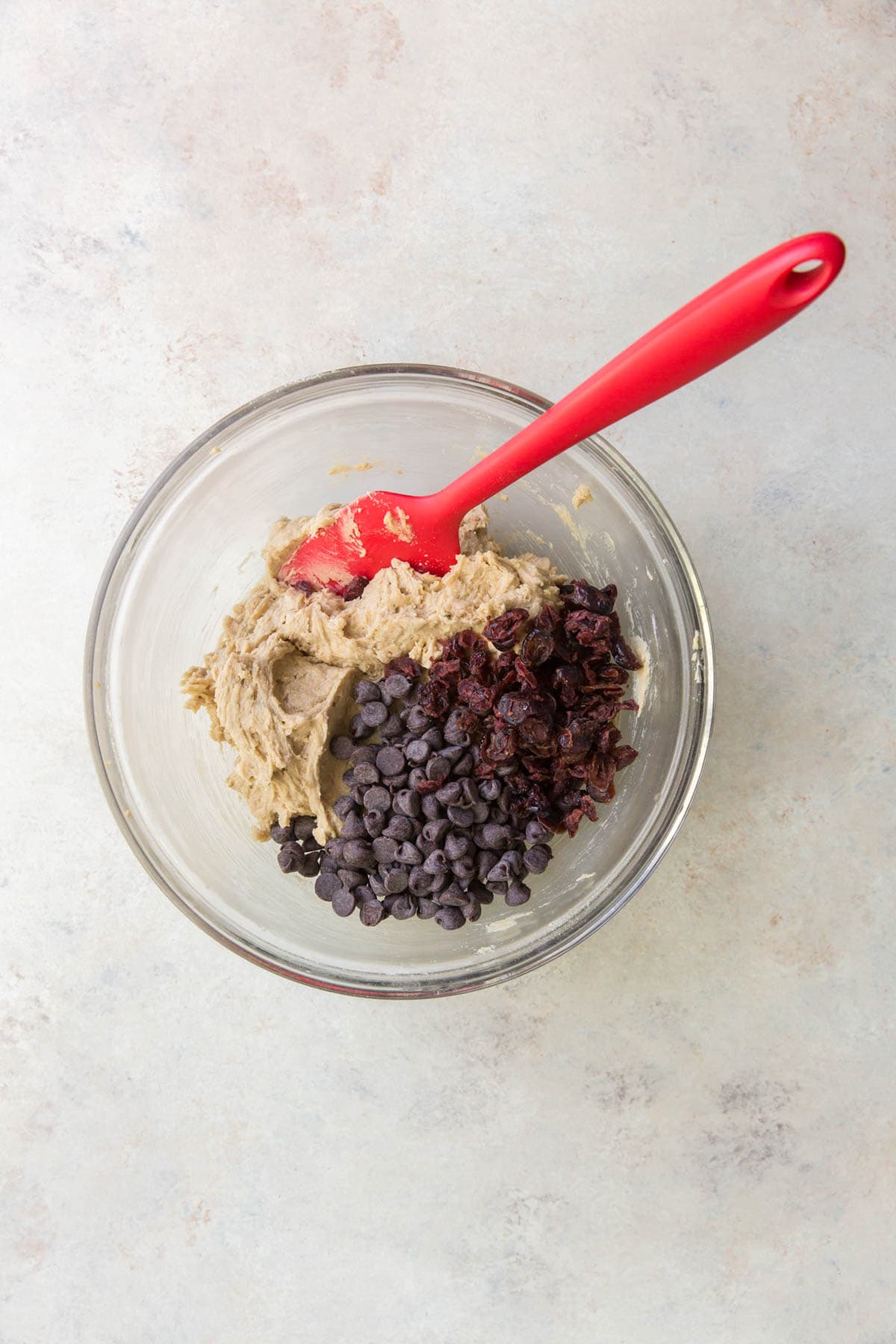 Bowl with cookie dough, chocolate chips and cranberries.