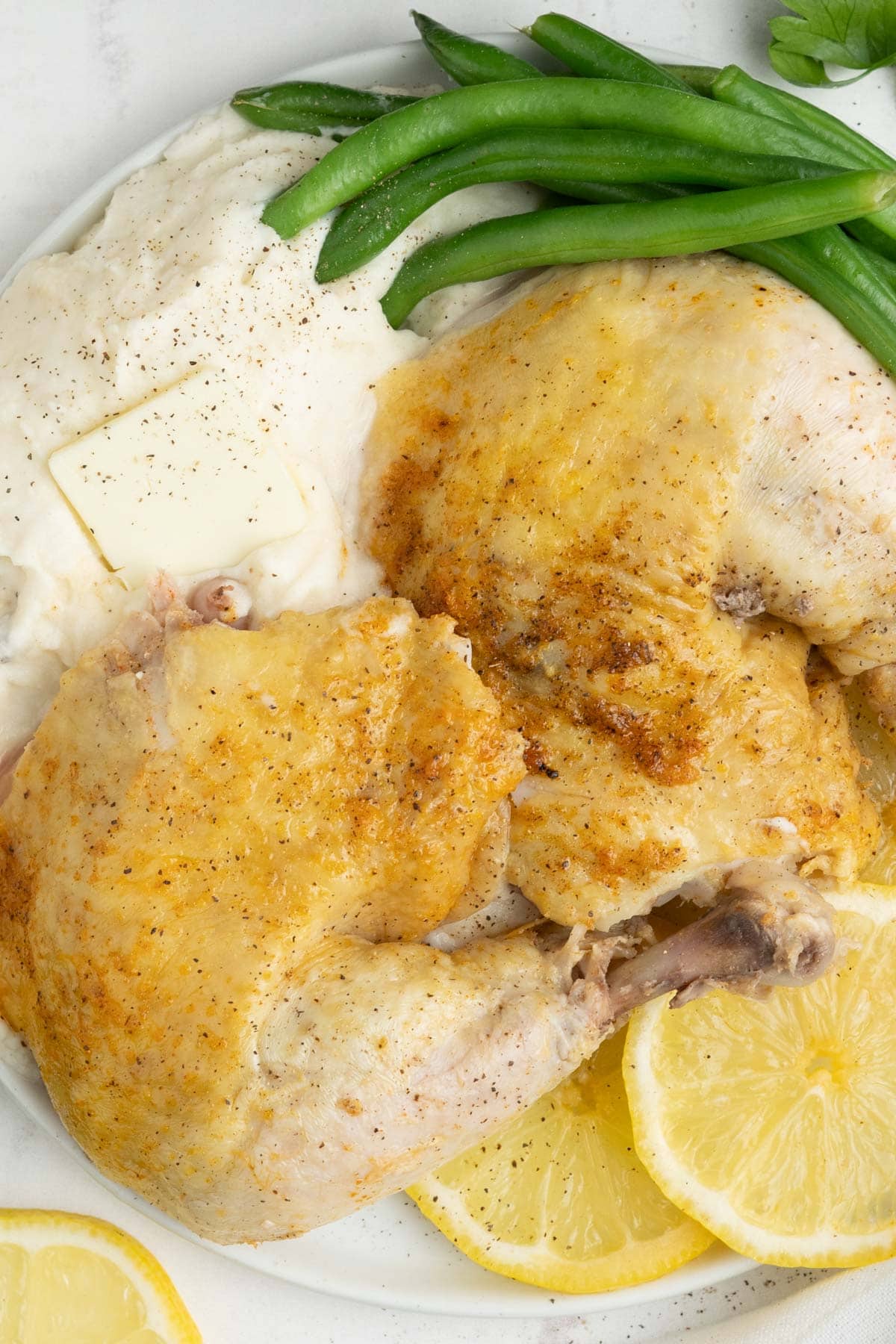 chicken pieces with mashed potatoes and green beans.