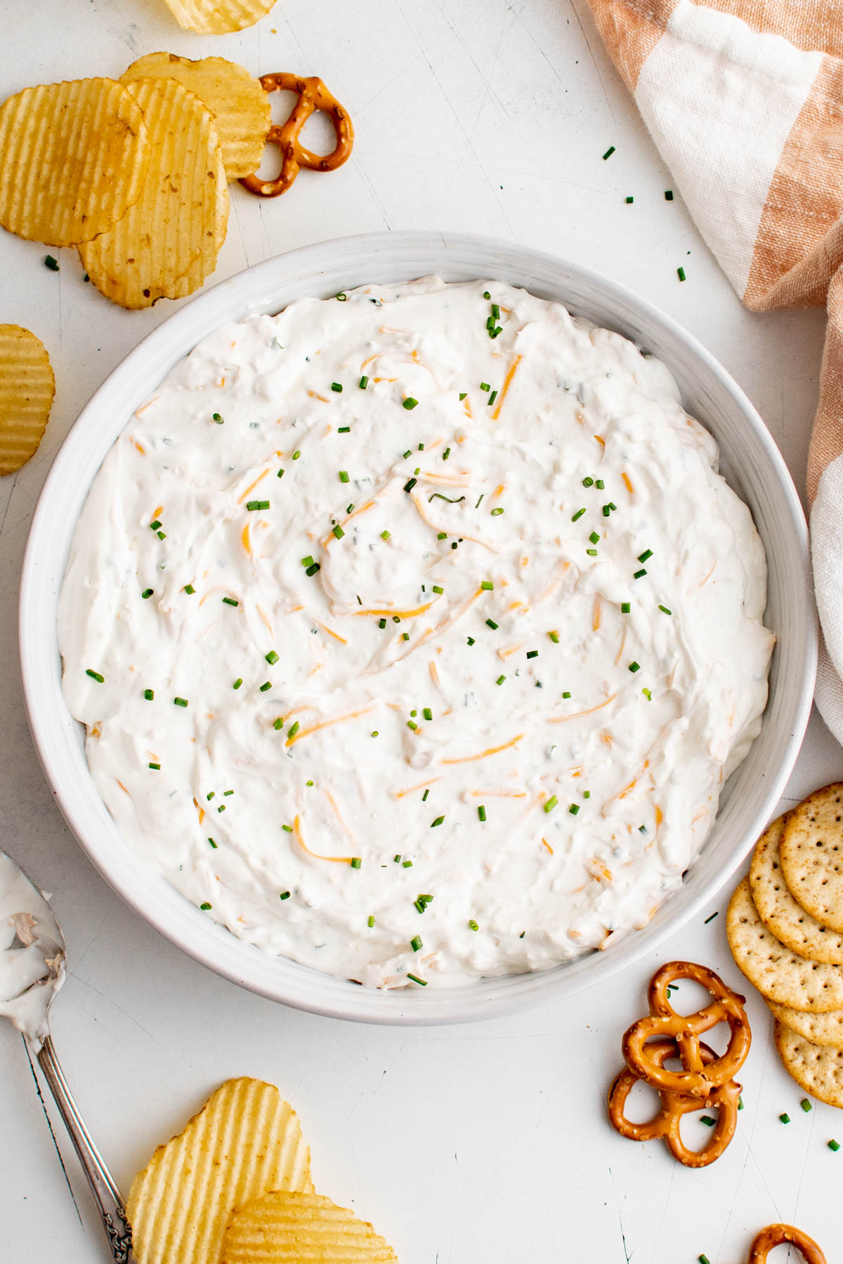 Cream cheese dip in a bowl with chives garnish.