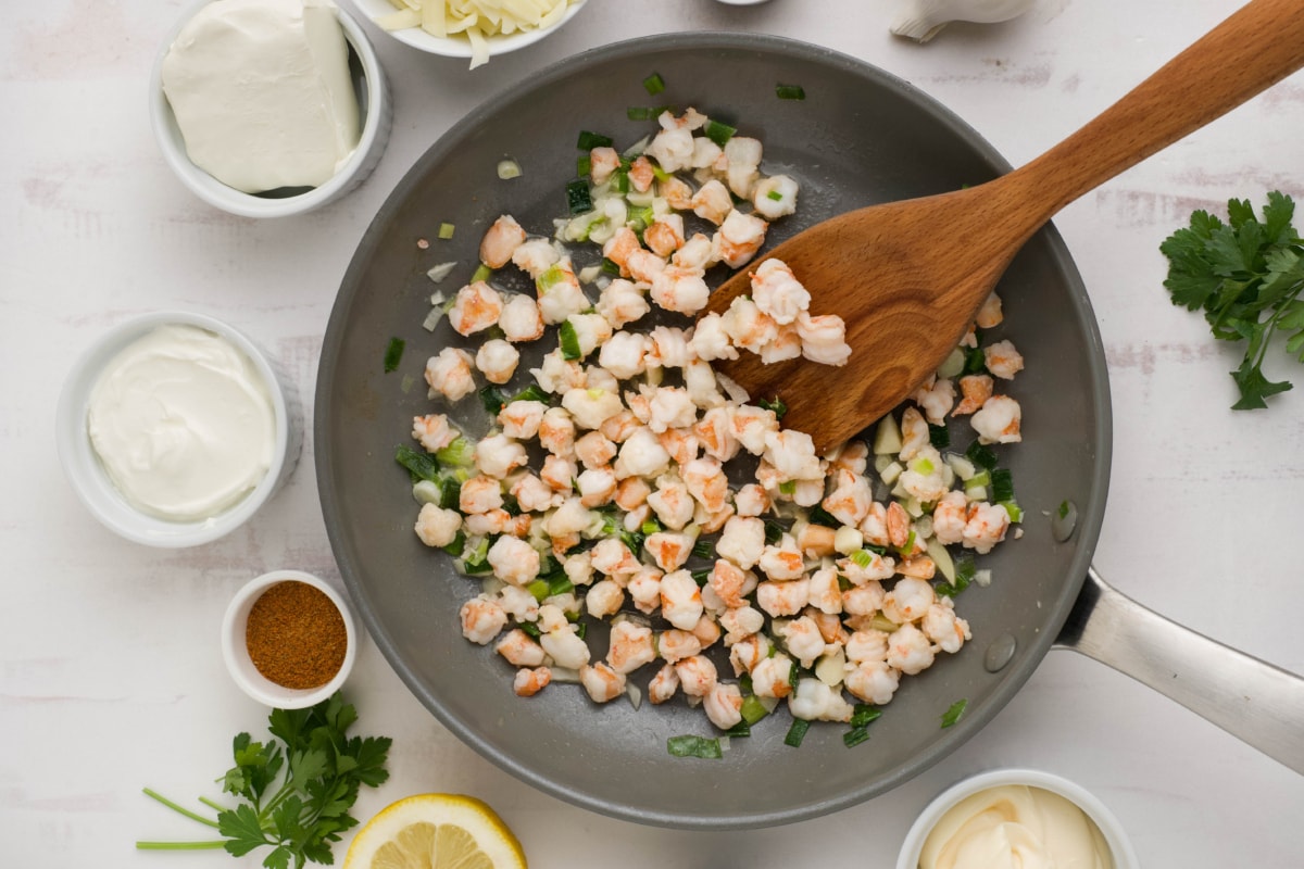 Chopped shrimp cooked in a skillet.
