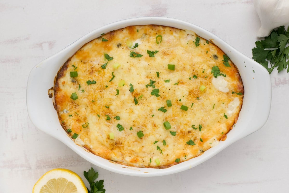 Baked shrimp dip in a white baking dish.