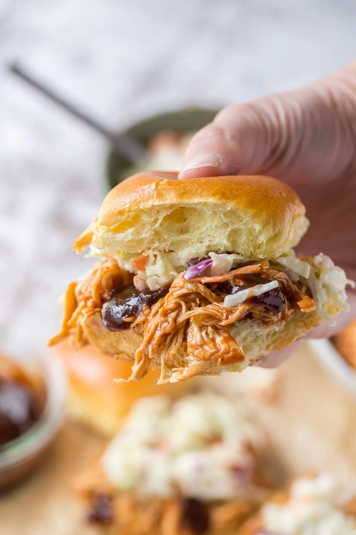 hand holding a bbq chicken slider