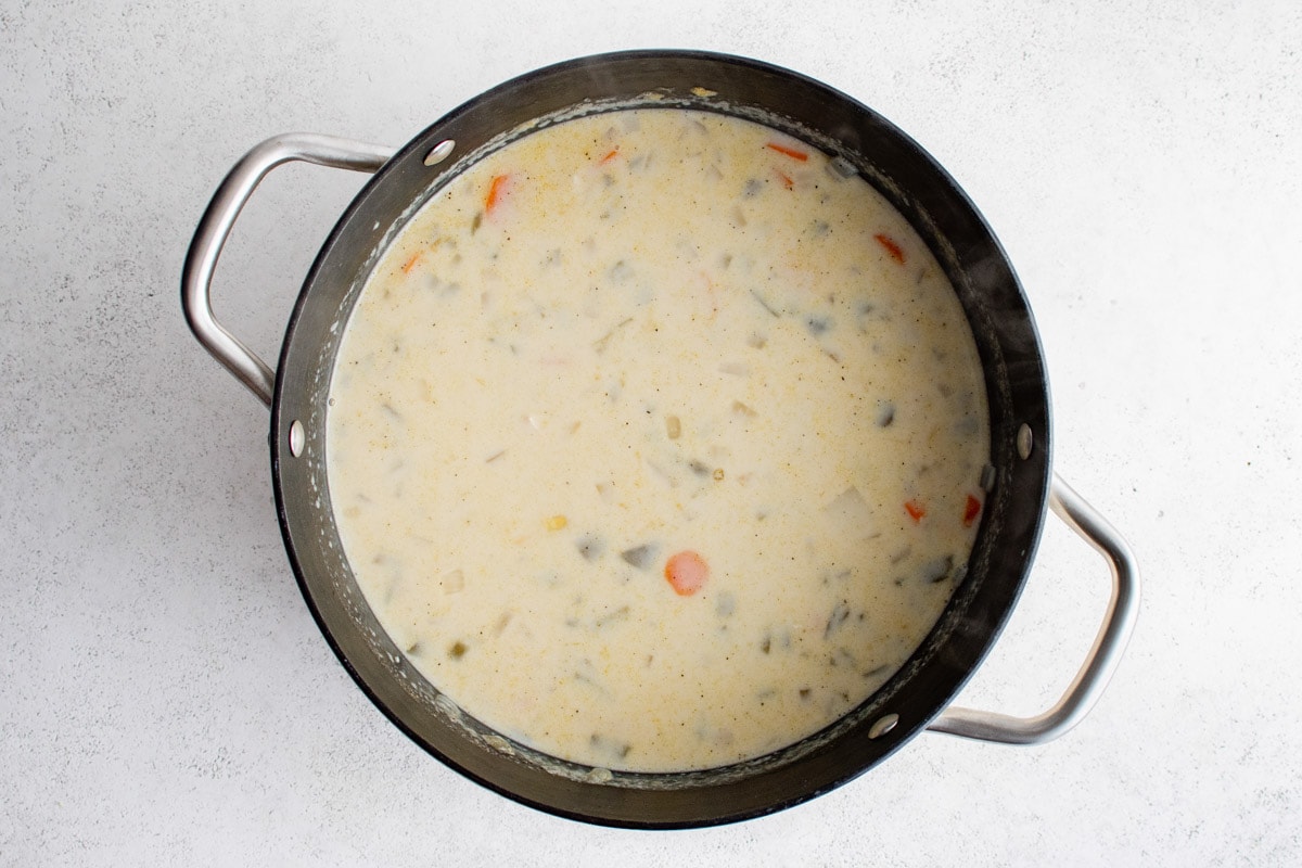 Creamy chicken corn soup in a large soup oit.