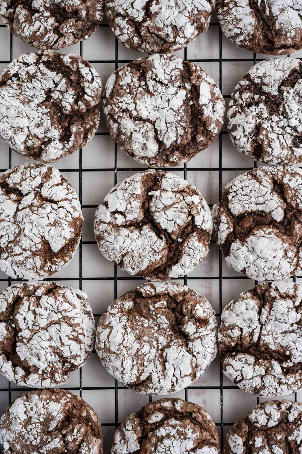 Chocolate crinkle cool whip cookies on a wire rack.