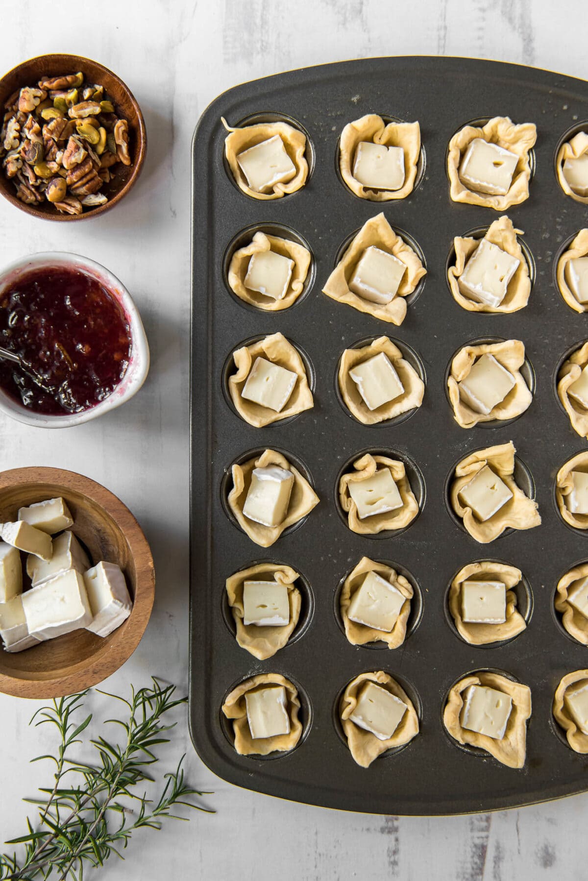 Crescent dough in muffin cups with squares of brie cheese. 