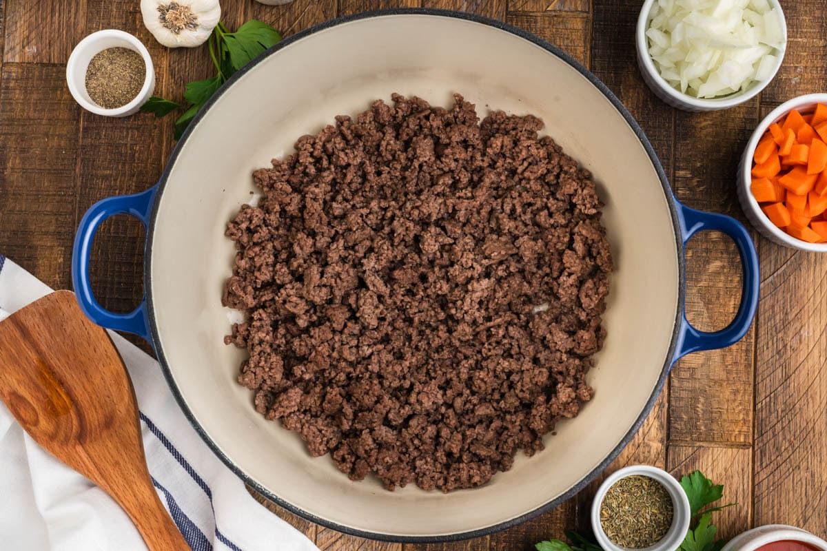 Ground beef cooking in a skillet.