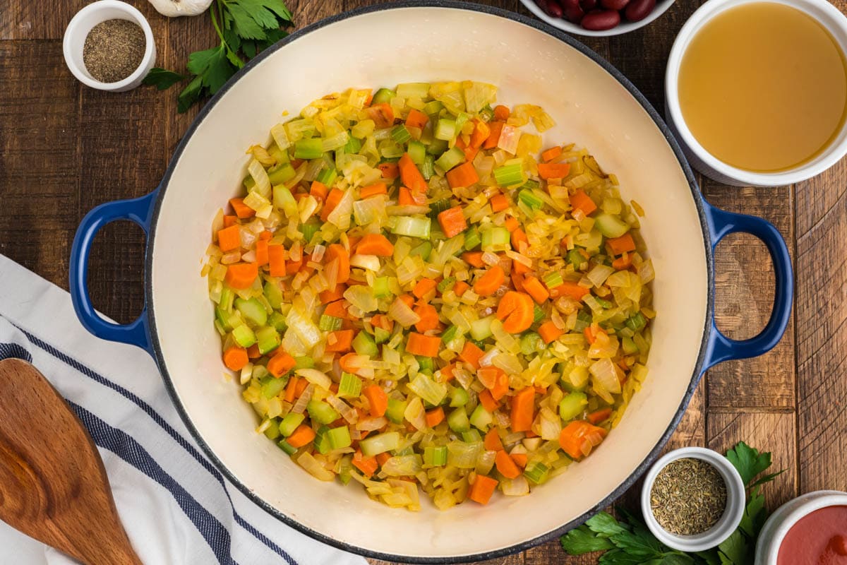 Carrots, celery and onions all diced and cooked in a skillet.