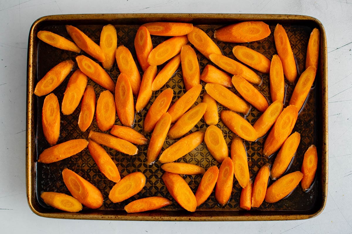 Cut carrots on a baking sheet.