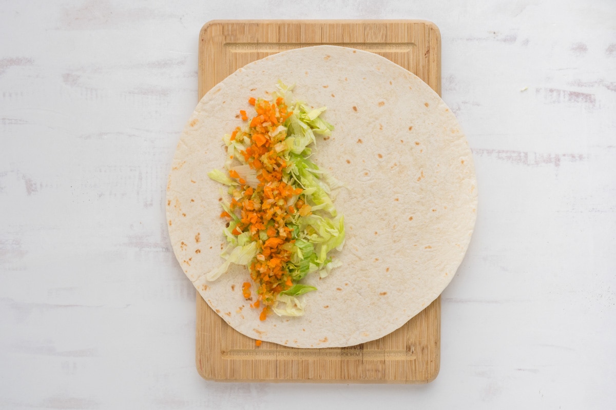 Lettuce and carrot mixture on a tortilla.