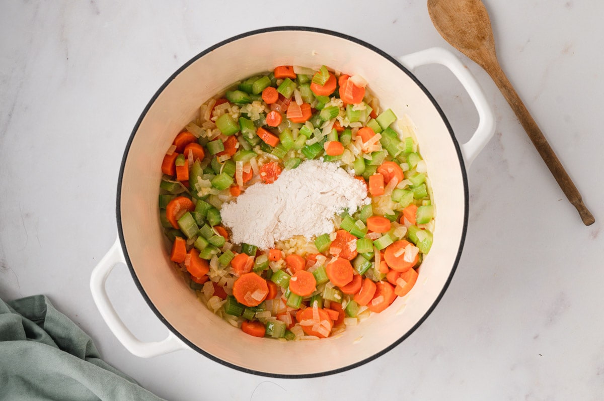 Diced carrots and celery with flour. sprinkled in the middle of the pot.