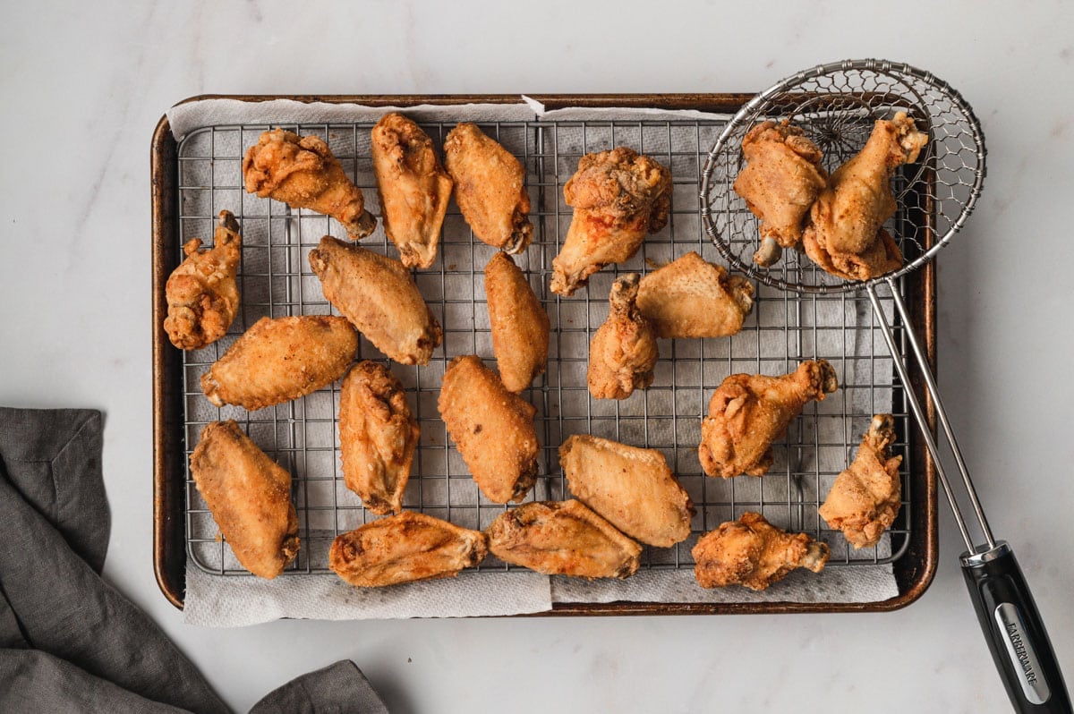 Chicken Wings, fried, laying on a wire rack.