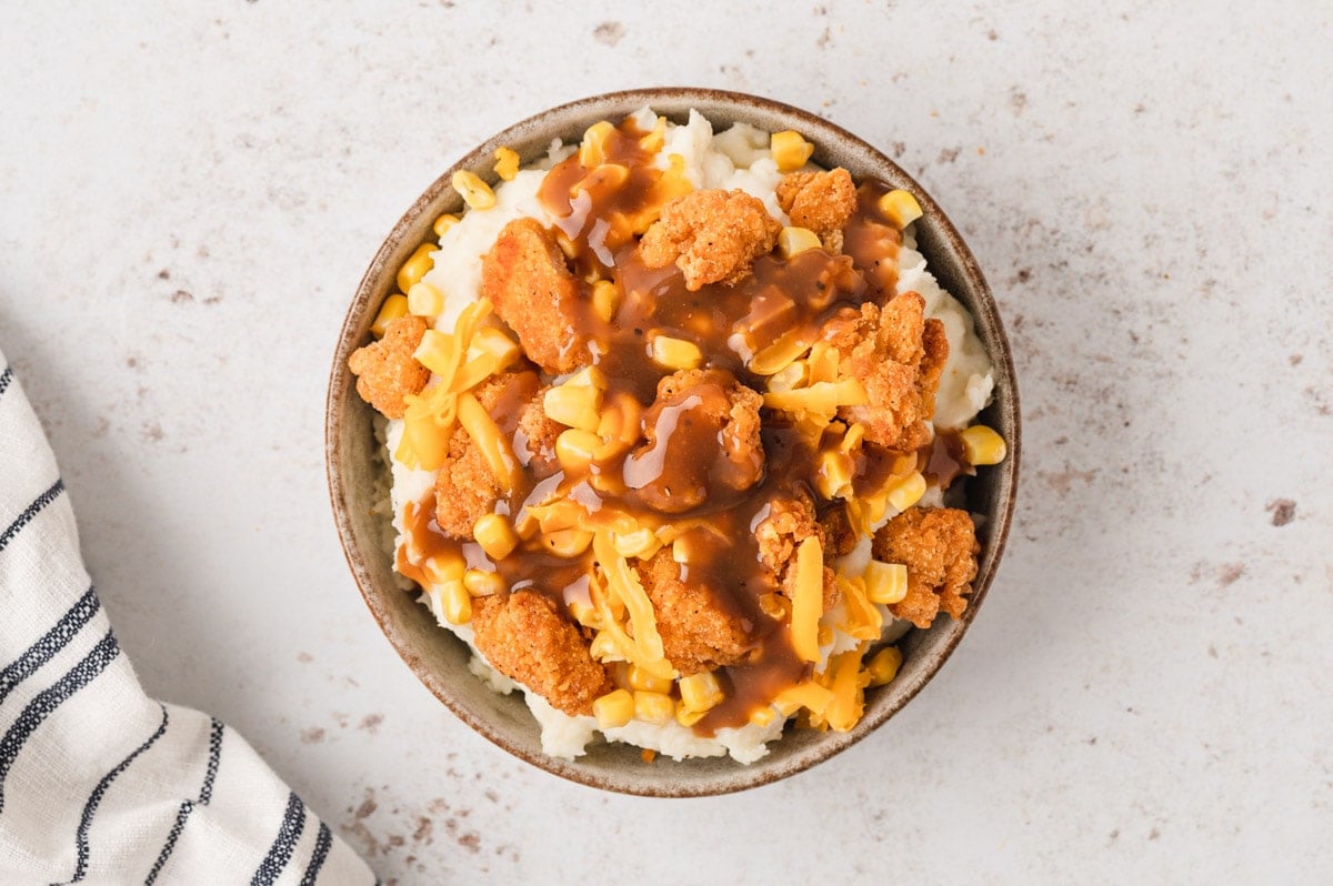 KFC Mashed potato bowl with popcorn chicken, cheese and corn and gravy.