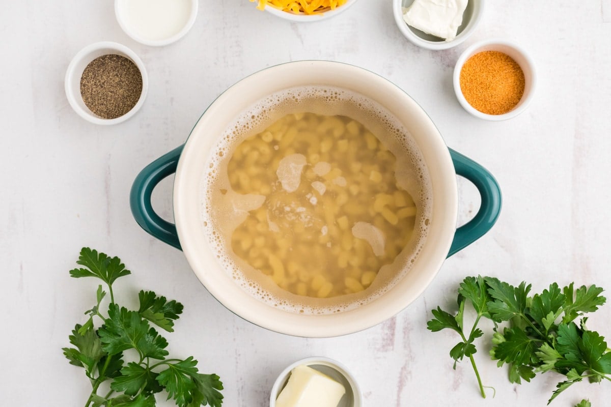 Cooked macaroni and water in a dish.