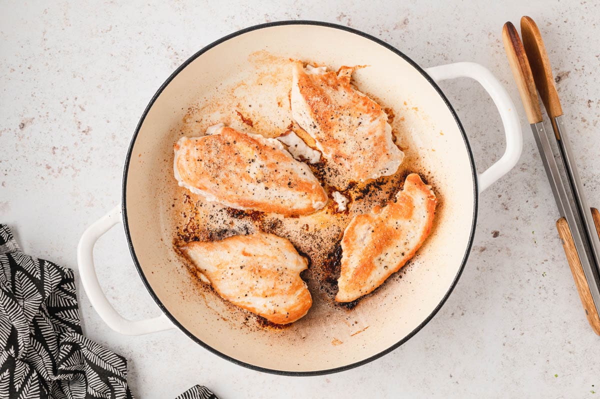 4 searedChicken breasts in a skillet.