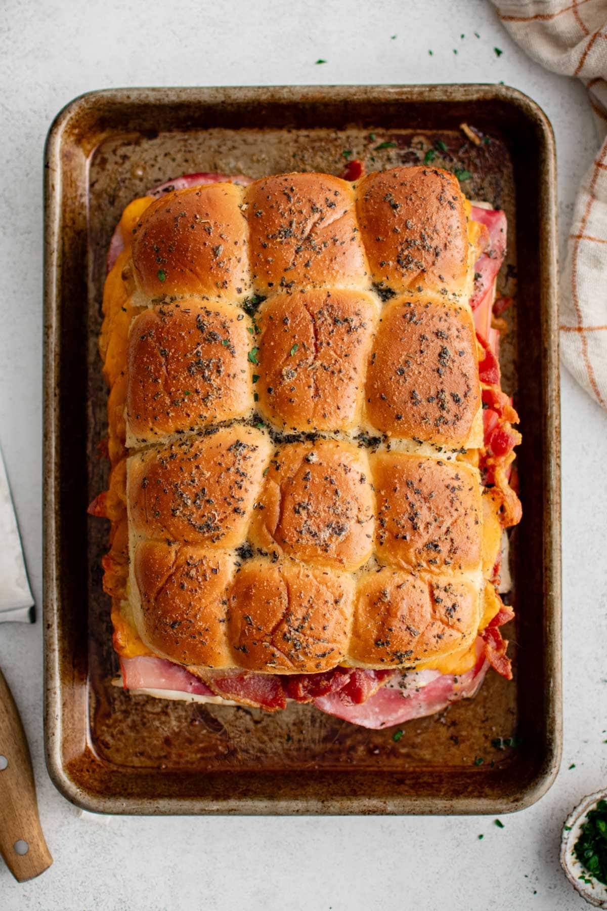 Baked club sliders on a baking sheet.