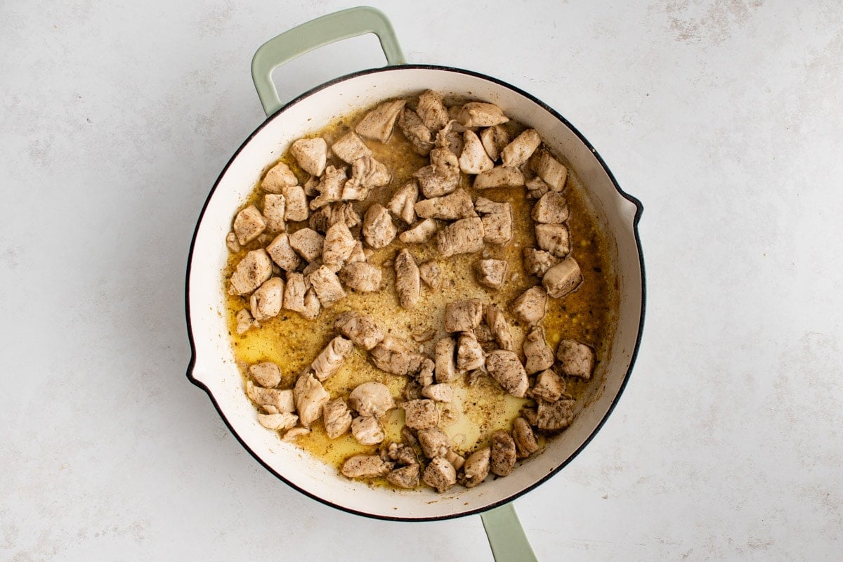 Cooked chicken pieces in a large skillet.