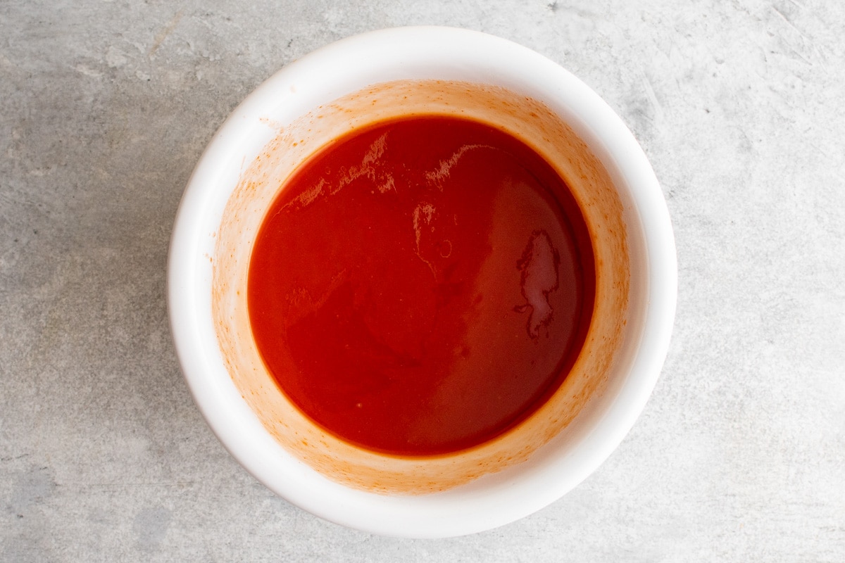 Red tomato juice in a bowl.