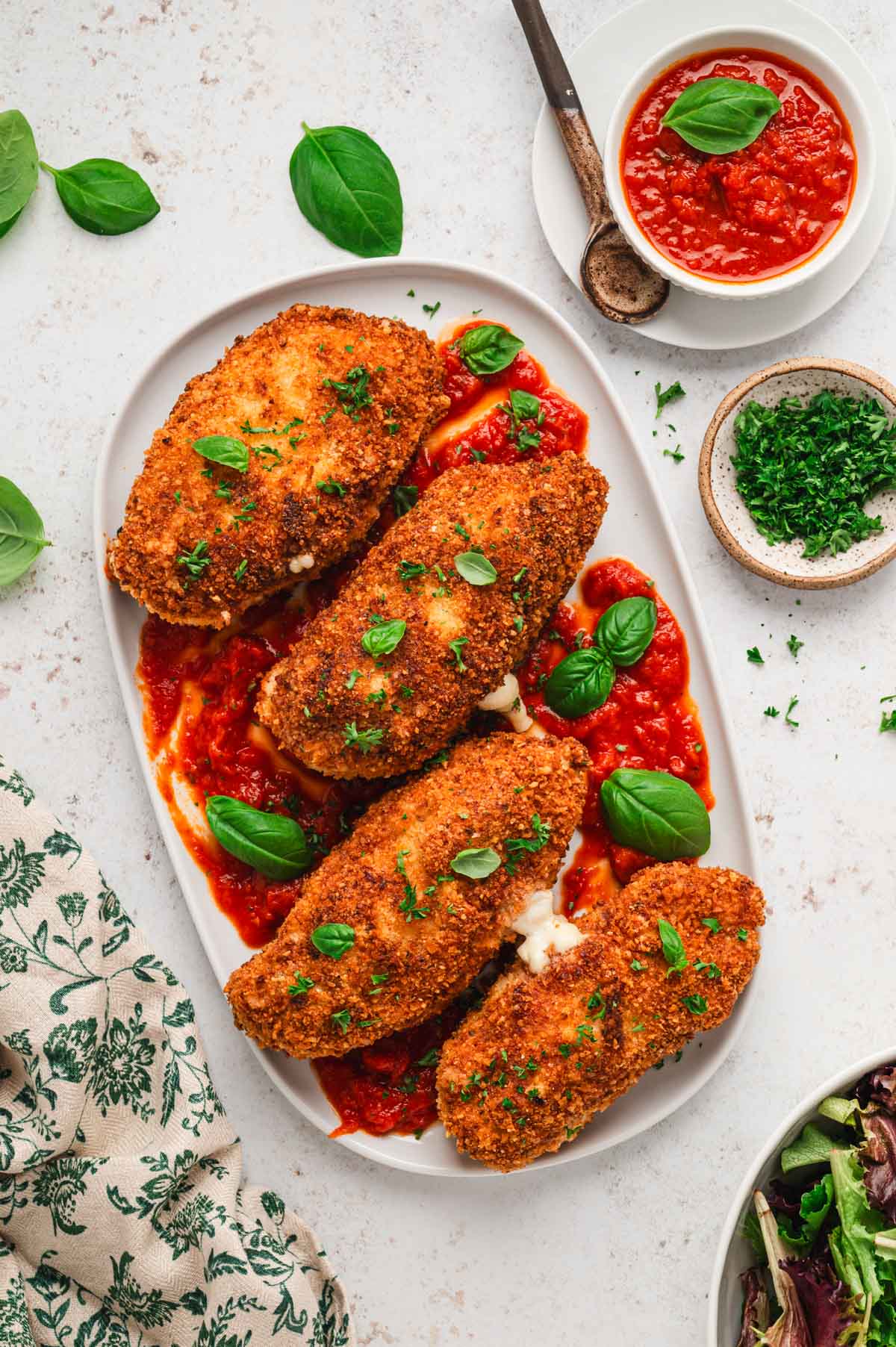 4 breaded and fried chicken breasts on a platter.