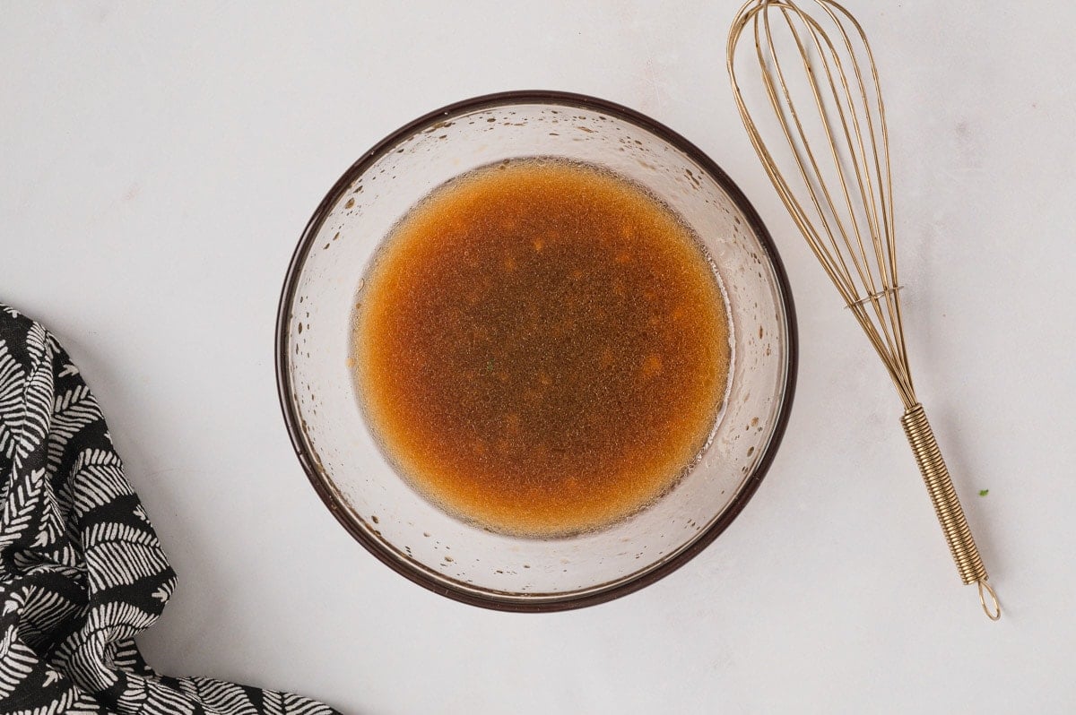 Salad dressing in a clear glass bowl.