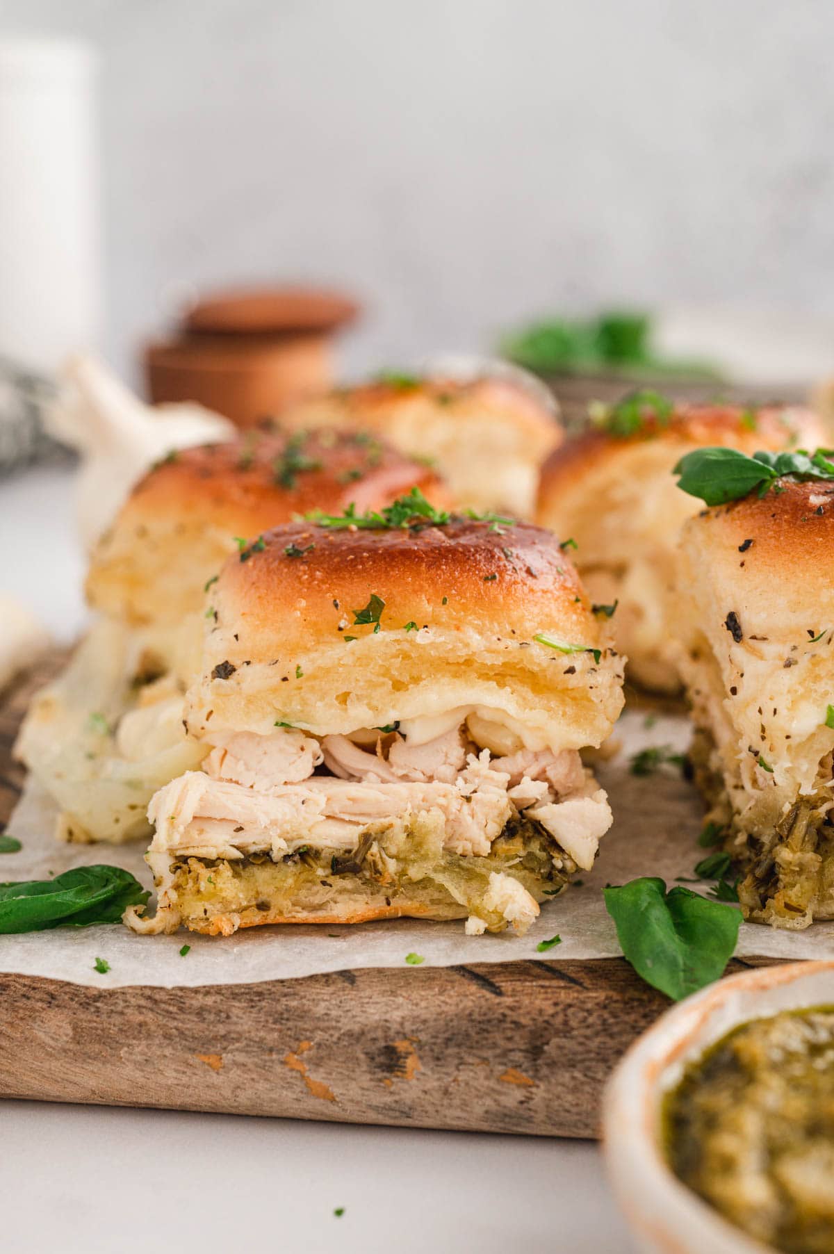 Chicken sliders, with pesto and melted mozzarella .