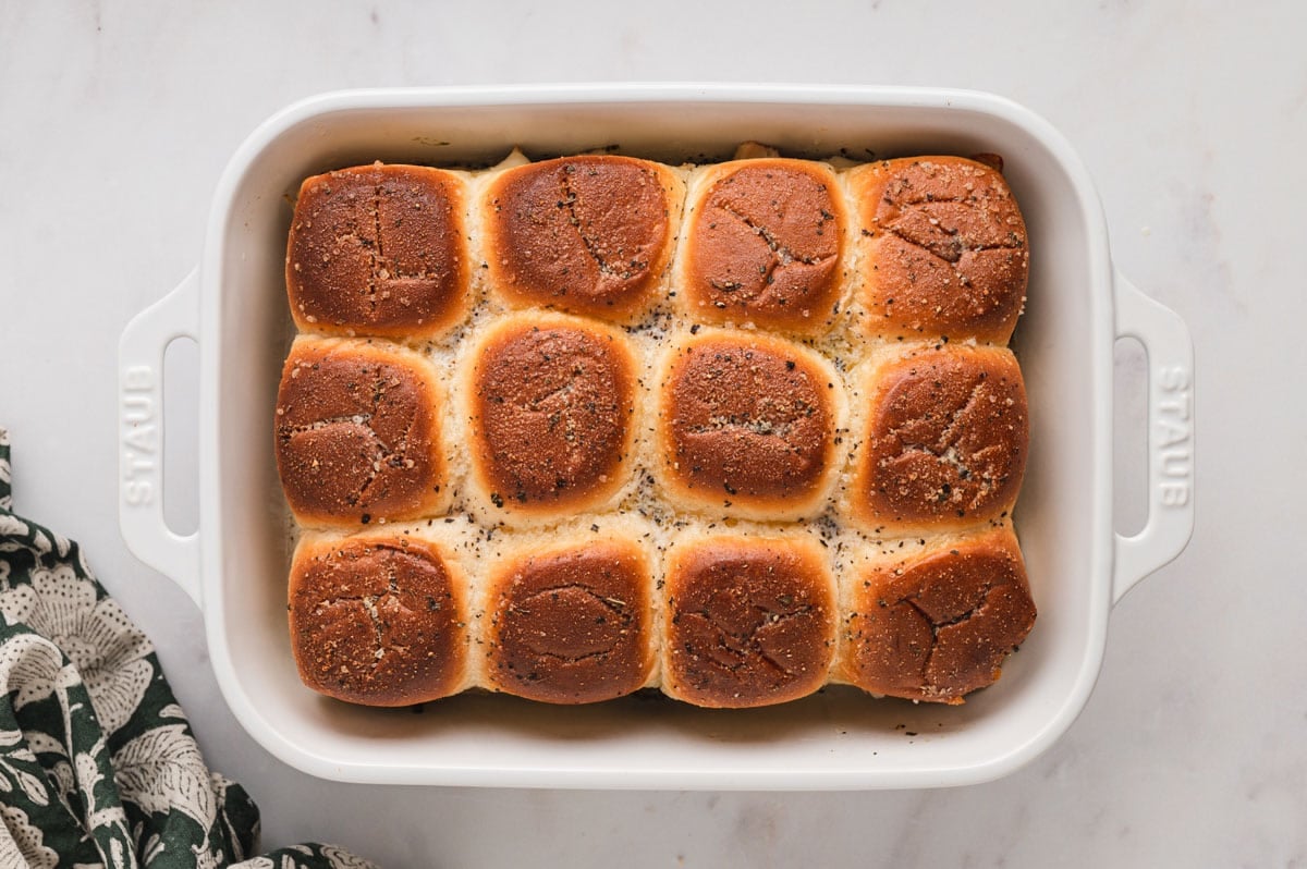 Baked slider rolls in a baking dish.