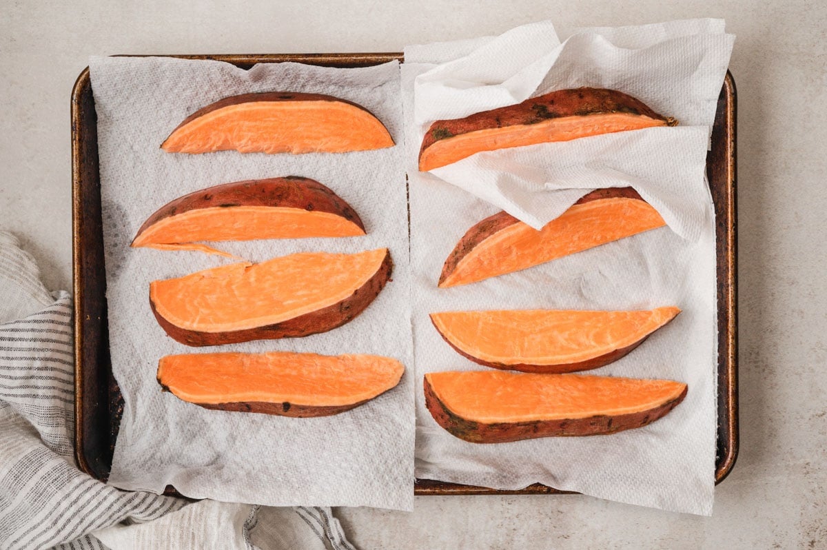Sweet potato wedges laying on paper towels.