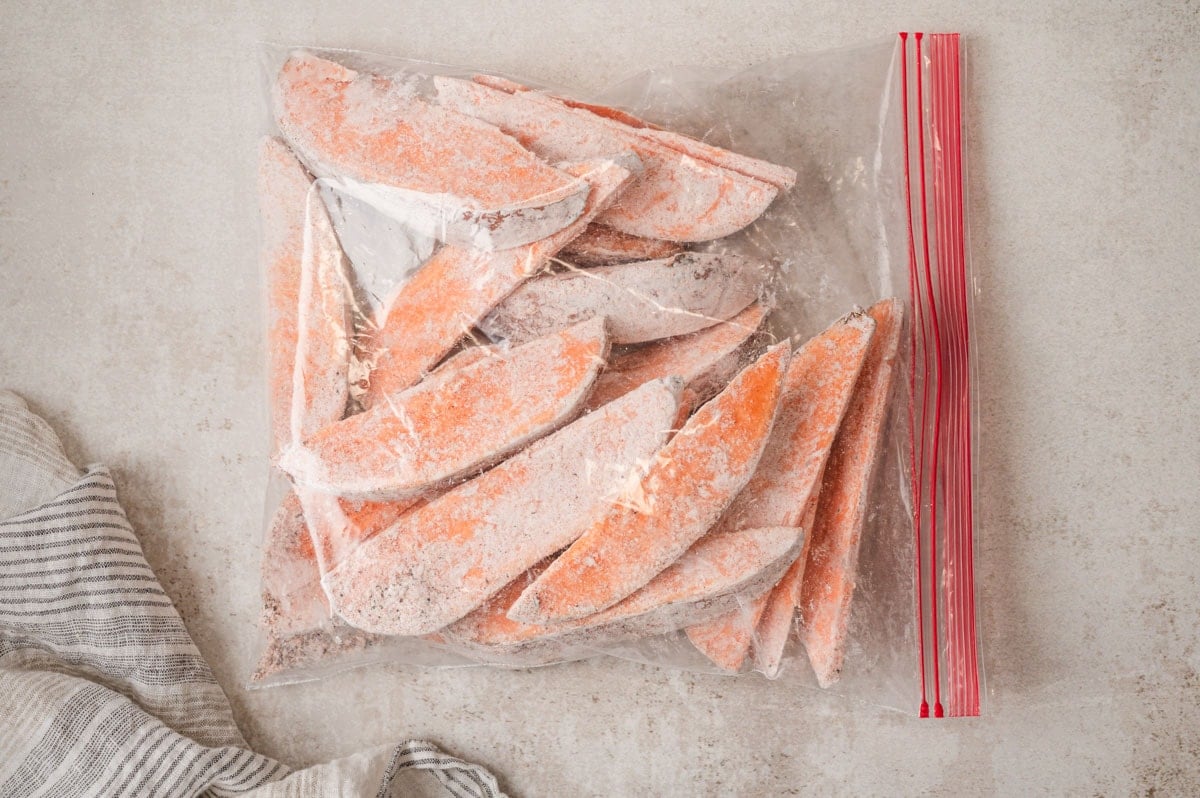 Sweet potato wedges in a ziploc bag with cornstarch and seasonings.