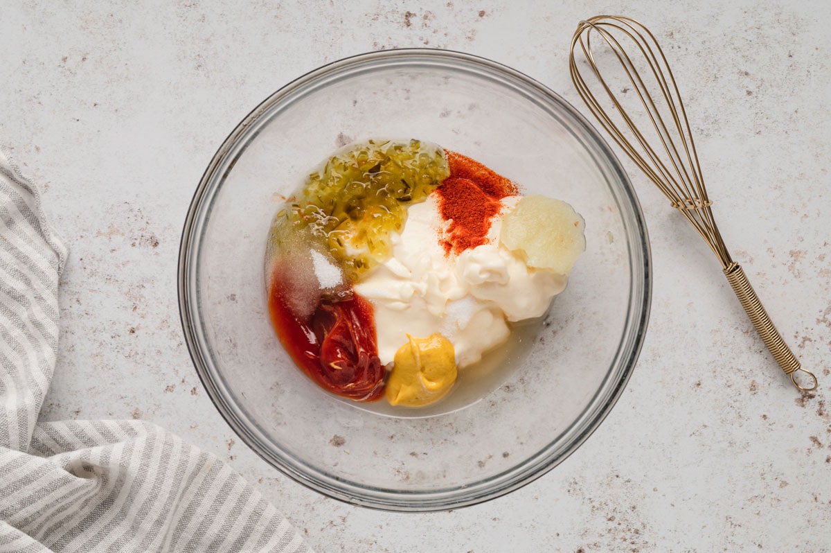 Mayo, pickle relish, seasonings in a clear glass bowl.