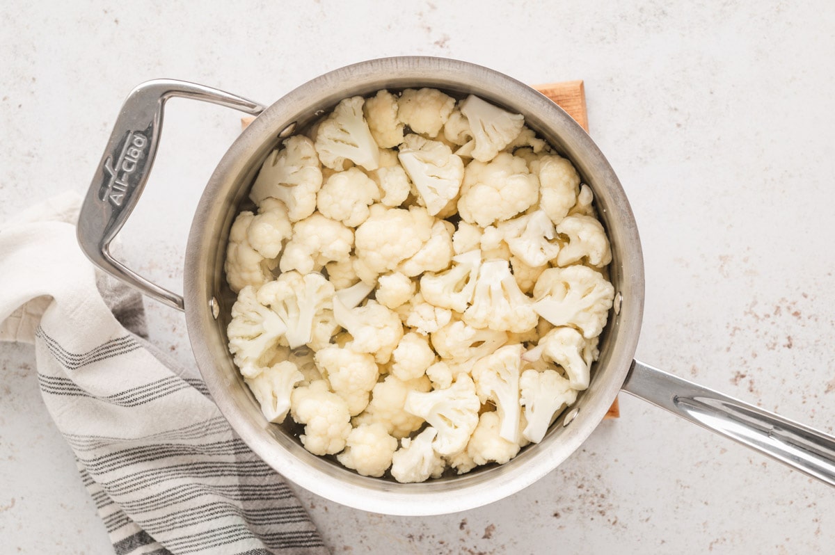 Cauliflower boiling in a sauce pan.