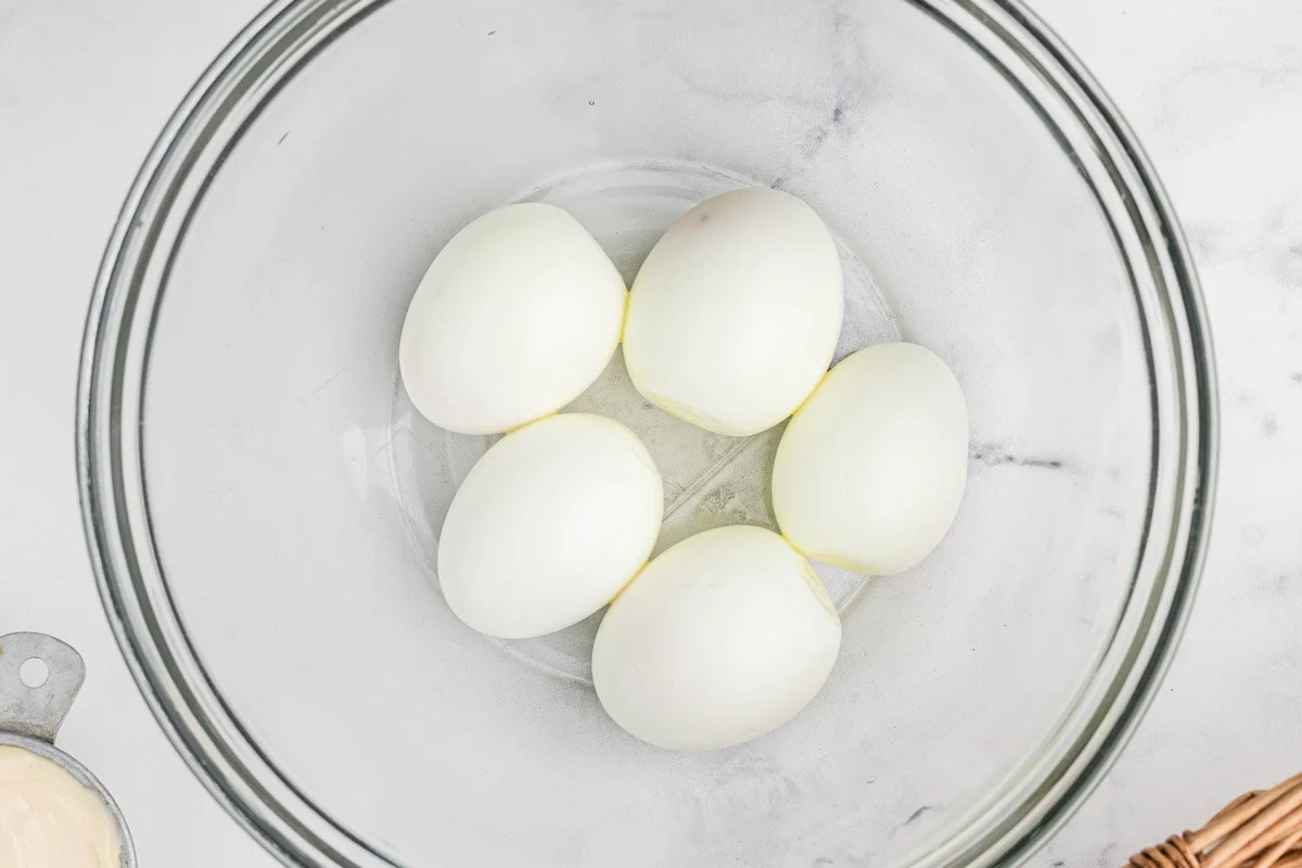 peeled eggs in a bowl