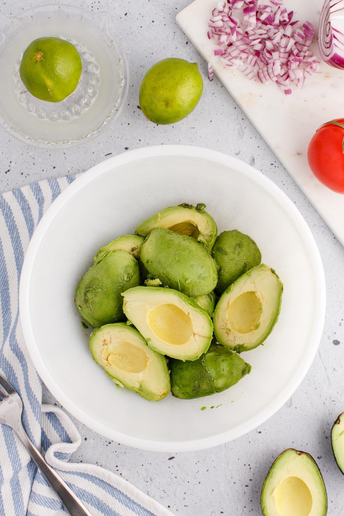 Bowl of avocados with the skins peeled and seeds removed.