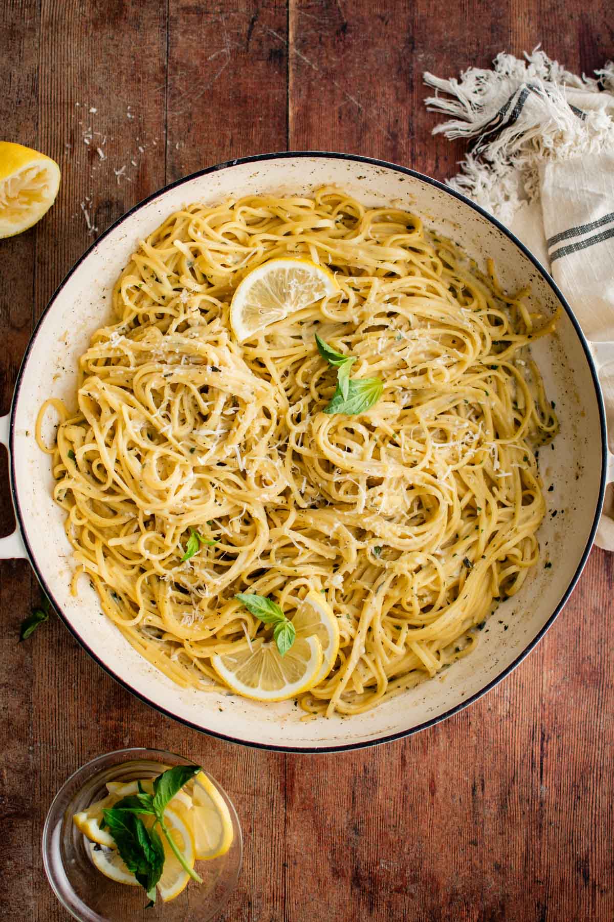 Pasta in a skillet with lemon and basil.